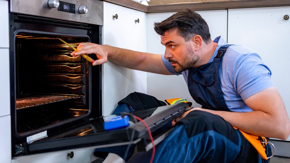 Technician repairing a cooking range